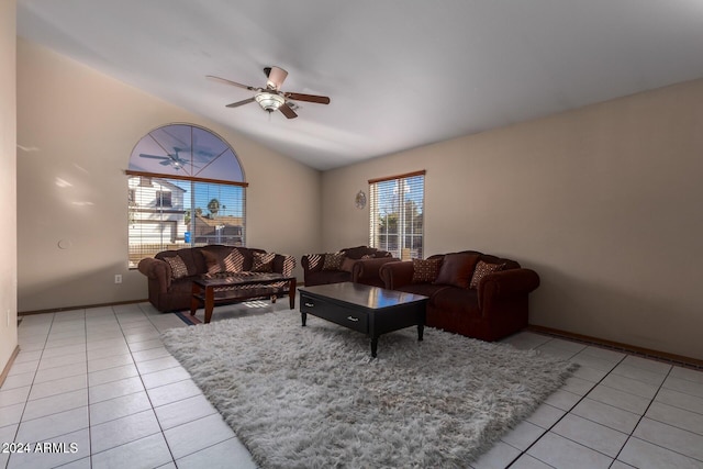 living room with ceiling fan, light tile patterned floors, and lofted ceiling