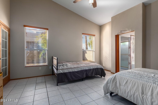 tiled bedroom with ceiling fan and lofted ceiling