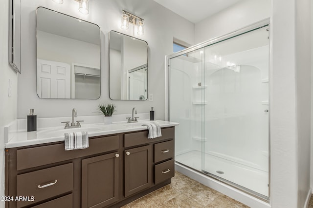 bathroom featuring a shower with door, tile patterned flooring, and vanity