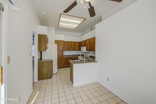522 W Dennis Ct, Tempe, AZ 85283 - kitchen featuring white appliances, wainscoting, light tile patterned floors, brown cabinets, and a ceiling fan