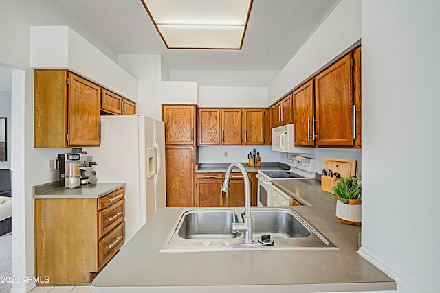 522 W Dennis Ct, Tempe, AZ 85283 - kitchen featuring white appliances, brown cabinetry, and a peninsula