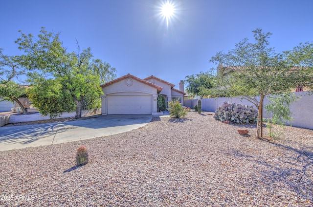 522 W Dennis Ct, Tempe, AZ 85283 - mediterranean / spanish-style home with concrete driveway, a garage, stucco siding, and a tiled roof