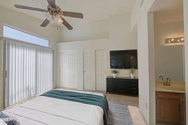 522 W Dennis Ct, Tempe, AZ 85283 - bedroom with light colored carpet, multiple closets, ceiling fan, and a towering ceiling