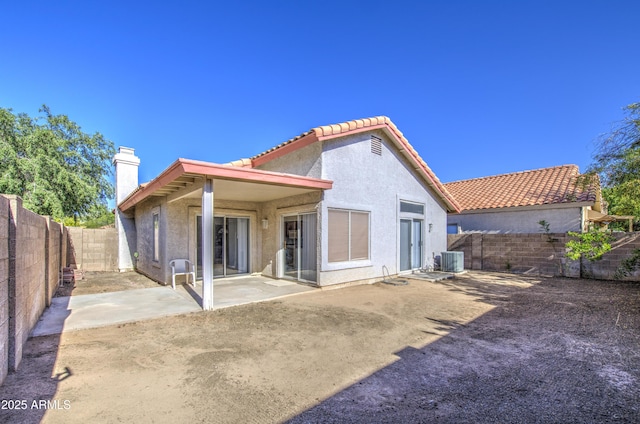 522 W Dennis Ct, Tempe, AZ 85283 - back of property featuring a fenced backyard, stucco siding, a tile roof, a patio area, and a chimney
