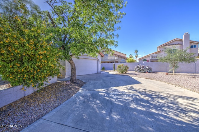 522 W Dennis Ct, Tempe, AZ 85283 - view of front of home featuring a garage, driveway, and stucco siding