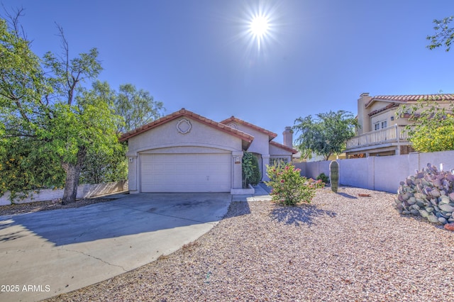 522 W Dennis Ct, Tempe, AZ 85283 - mediterranean / spanish house featuring concrete driveway, stucco siding, an attached garage, and a tiled roof