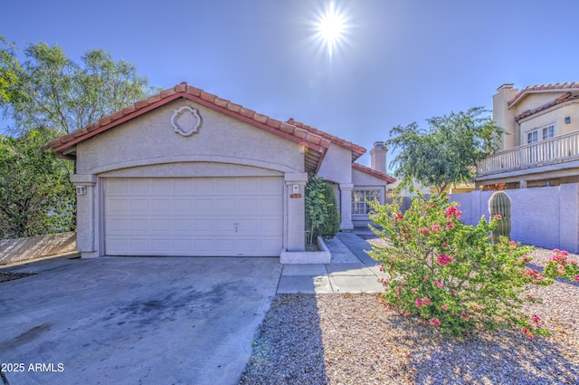 522 W Dennis Ct, Tempe, AZ 85283 - mediterranean / spanish home with concrete driveway, a tiled roof, stucco siding, and a garage
