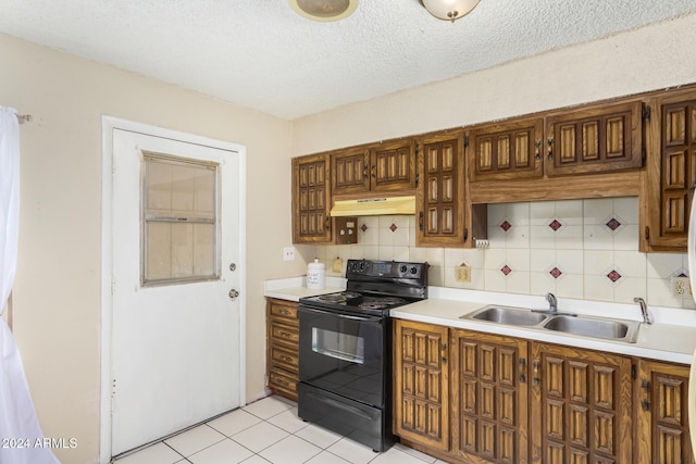 kitchen featuring backsplash, sink, electric range, light tile patterned floors, and a textured ceiling