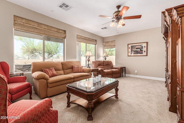 carpeted living room with ceiling fan