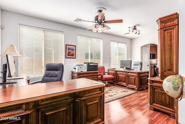 office space with light wood-type flooring and ceiling fan