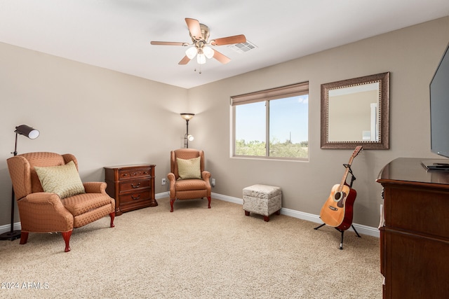 sitting room featuring ceiling fan and carpet floors