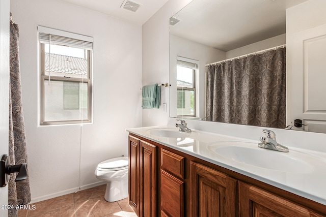 bathroom featuring tile patterned flooring, vanity, and toilet