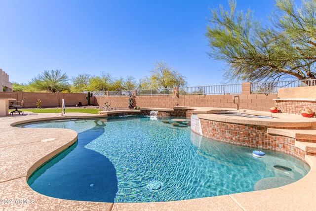 view of pool featuring pool water feature and an in ground hot tub