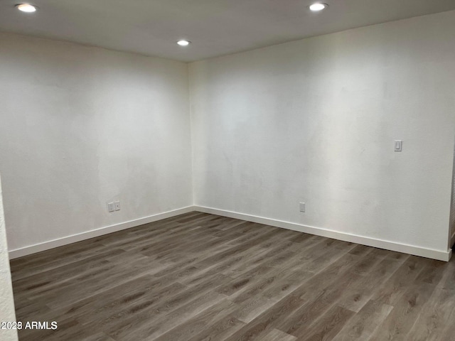 spare room with dark wood-type flooring