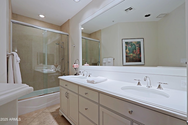 bathroom with tile patterned floors, vanity, and enclosed tub / shower combo