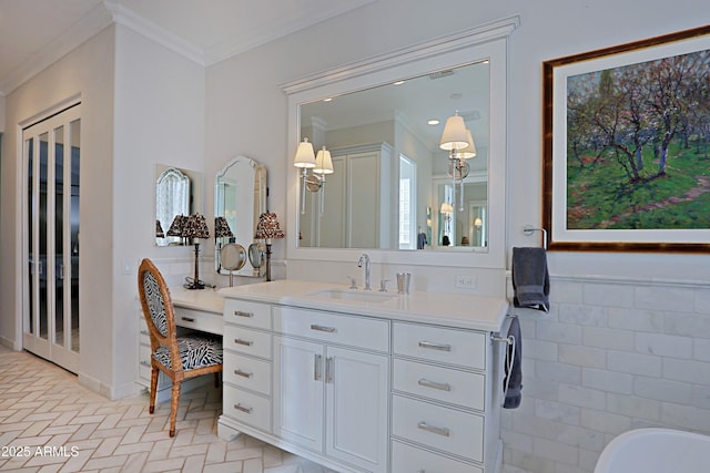 bathroom featuring vanity, ornamental molding, and a tub