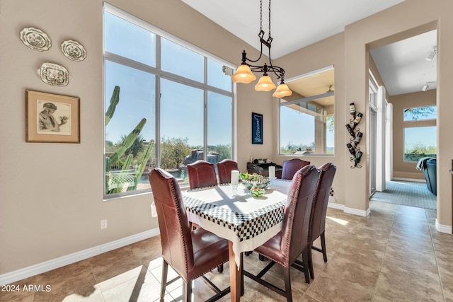 dining room featuring a wealth of natural light and an inviting chandelier