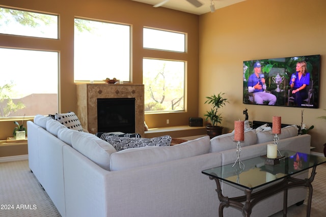 carpeted living room featuring a premium fireplace