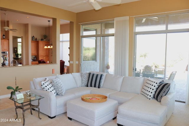 living room featuring ceiling fan and a wealth of natural light