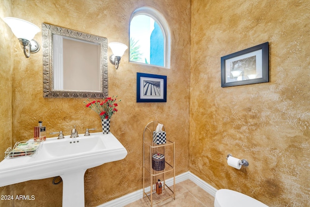 bathroom with toilet and tile patterned floors