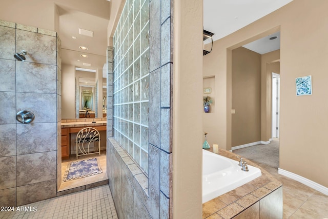 bathroom with tile patterned floors and tiled tub