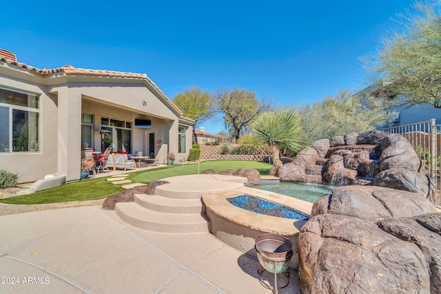 view of pool with a jacuzzi and a patio area