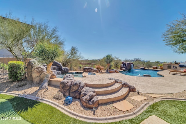 view of pool featuring pool water feature and a patio