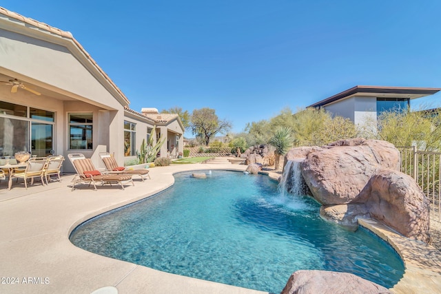 view of pool with pool water feature and a patio