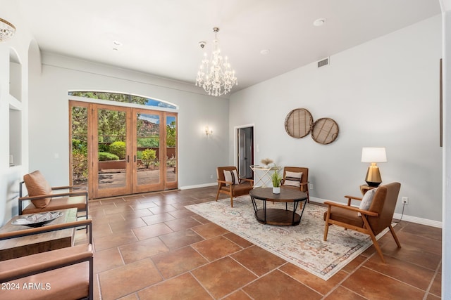 sitting room with dark tile patterned flooring, french doors, and a chandelier