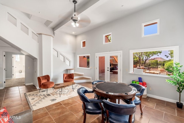 interior space featuring a high ceiling, ceiling fan, french doors, and tile patterned floors