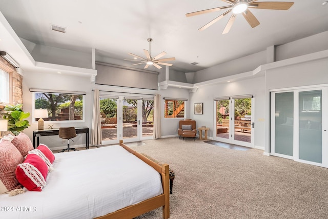 carpeted bedroom featuring a towering ceiling, french doors, access to exterior, and ceiling fan