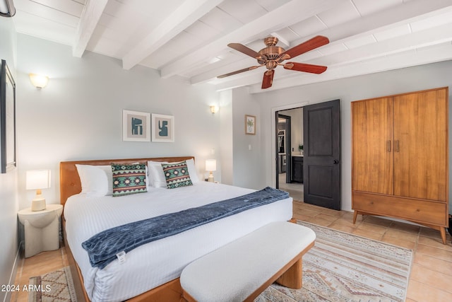 bedroom with ceiling fan, beam ceiling, and light tile patterned floors