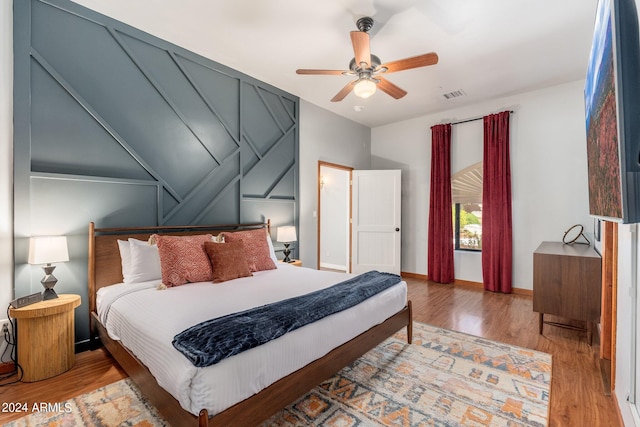 bedroom with light wood-type flooring and ceiling fan