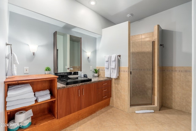 bathroom featuring tile patterned floors, vanity, and a shower with shower door