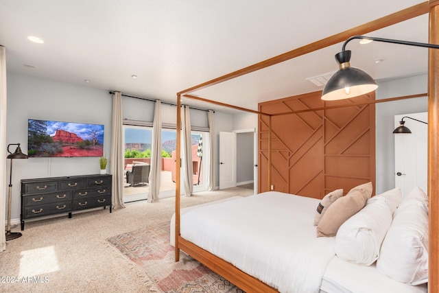 carpeted bedroom featuring access to outside and a barn door