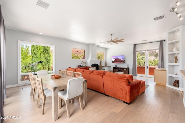 dining space featuring ceiling fan, a wealth of natural light, and light hardwood / wood-style flooring