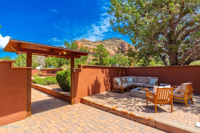 view of patio / terrace with a mountain view and an outdoor hangout area