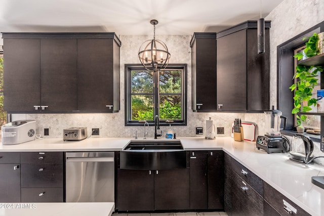 kitchen with hanging light fixtures, stainless steel dishwasher, an inviting chandelier, and dark brown cabinetry