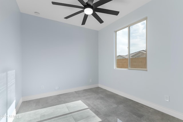 unfurnished room with ceiling fan and baseboards