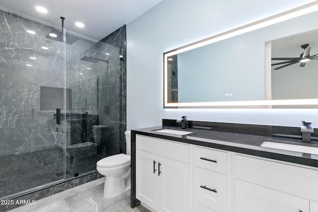 bathroom featuring ceiling fan, double vanity, a sink, and toilet