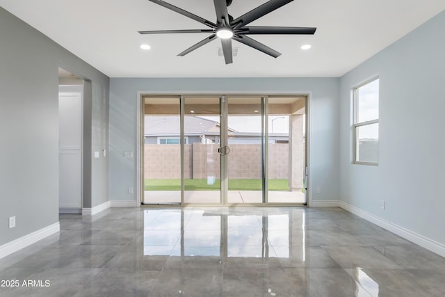 empty room featuring baseboards, a wealth of natural light, and recessed lighting