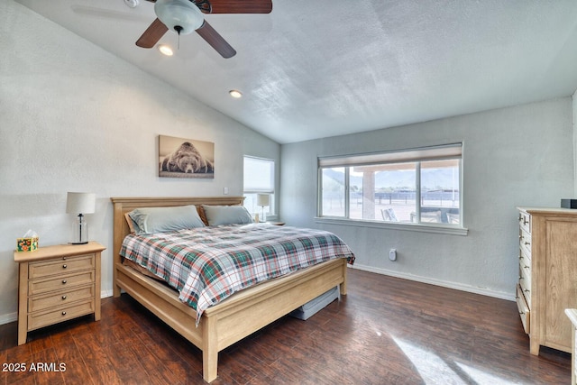 bedroom with a textured ceiling, dark hardwood / wood-style floors, vaulted ceiling, and ceiling fan