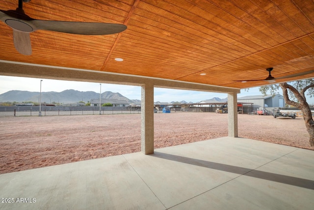 view of patio featuring a mountain view and ceiling fan