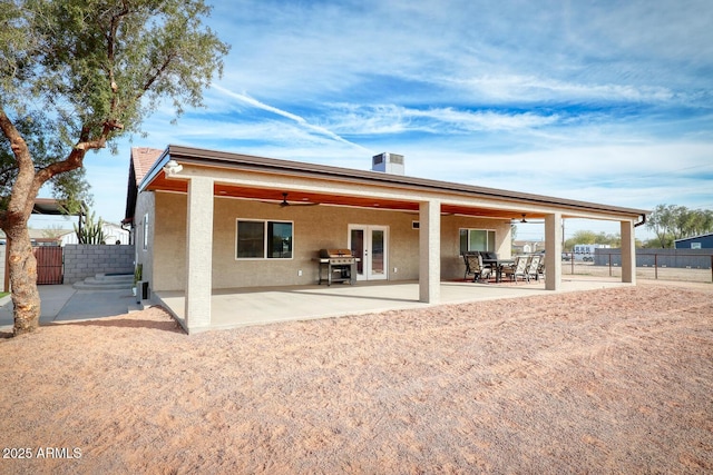 back of property featuring french doors, ceiling fan, and a patio area