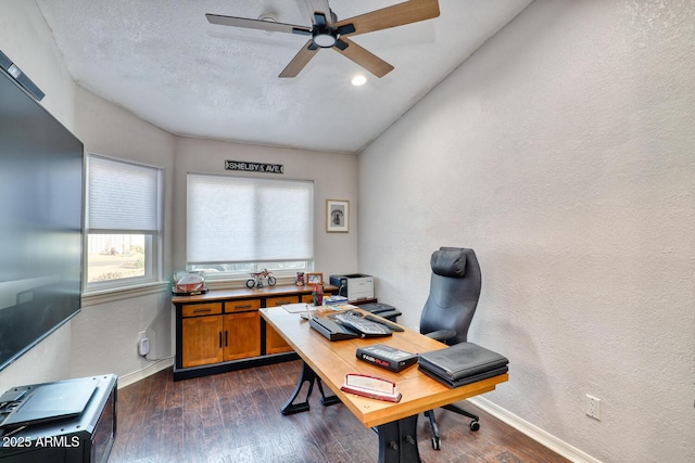 home office with ceiling fan and dark hardwood / wood-style flooring