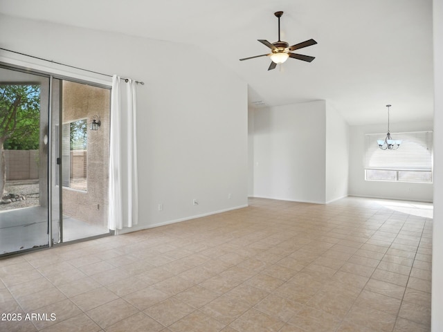 empty room with a chandelier, vaulted ceiling, a ceiling fan, and baseboards