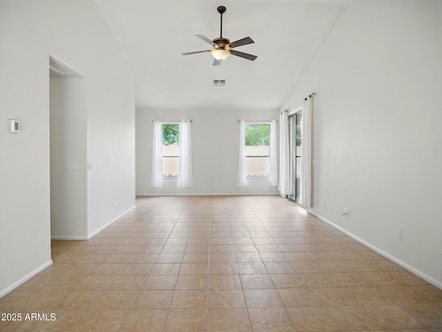 unfurnished room with vaulted ceiling, a ceiling fan, baseboards, and light tile patterned floors