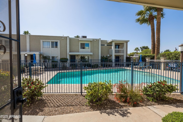 pool with a patio and fence