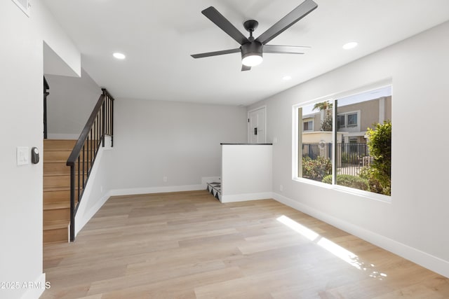 unfurnished living room featuring stairway, baseboards, light wood finished floors, recessed lighting, and ceiling fan