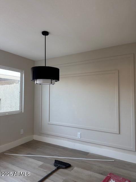 room details featuring baseboards and wood finished floors